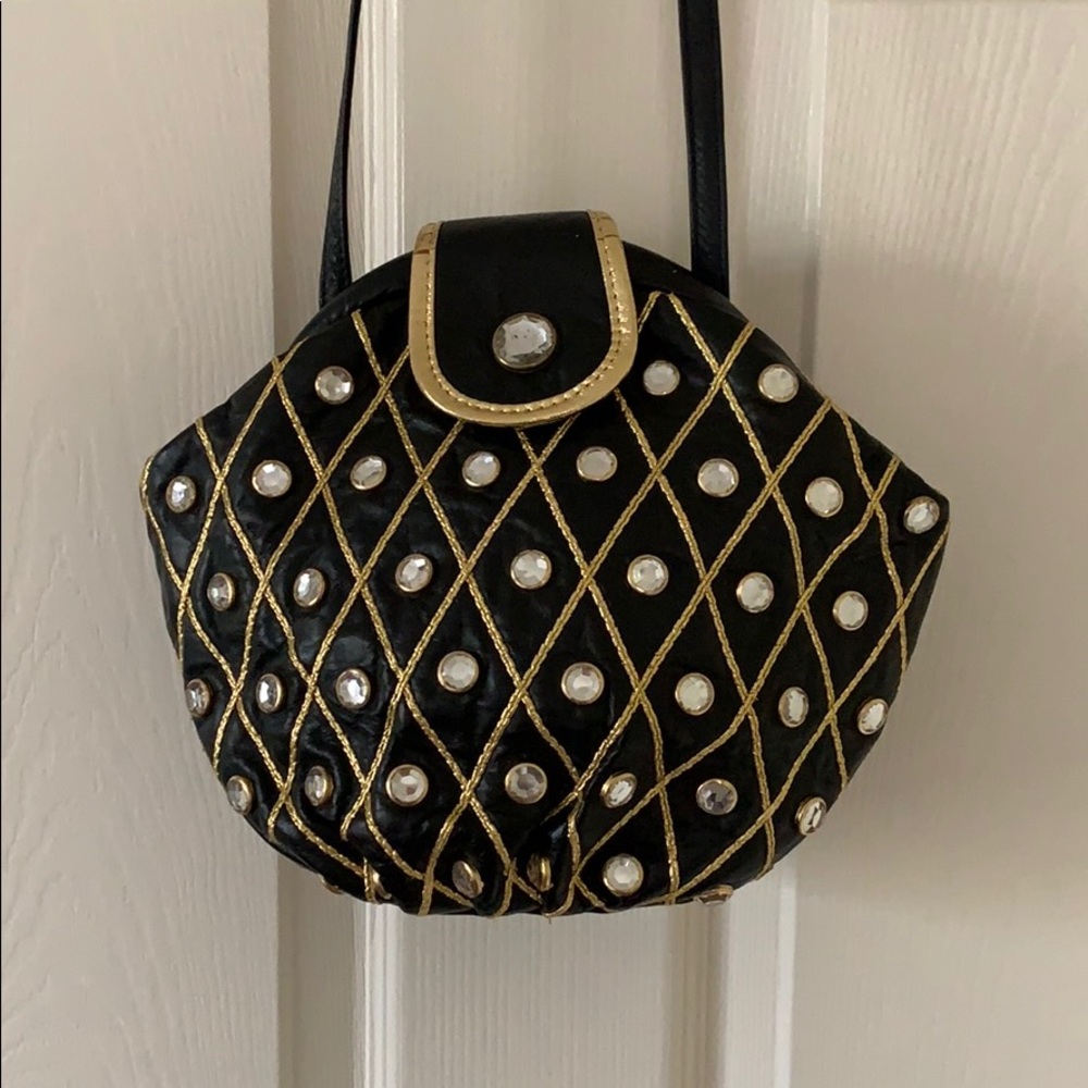 Small black and gold clutch with strap
